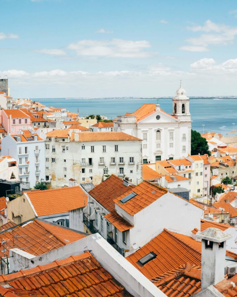 Stunning panoramic view of Lisbon, Portugal, featuring the iconic red rooftops, the picturesque hills. one of Best places to visit in europe 2025