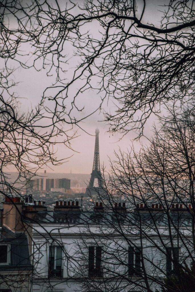 View of the Eiffel Tower in Paris at sunset, showcasing the iconic landmark against the beautiful Parisian sky. One of Best places to visit in europe 2025