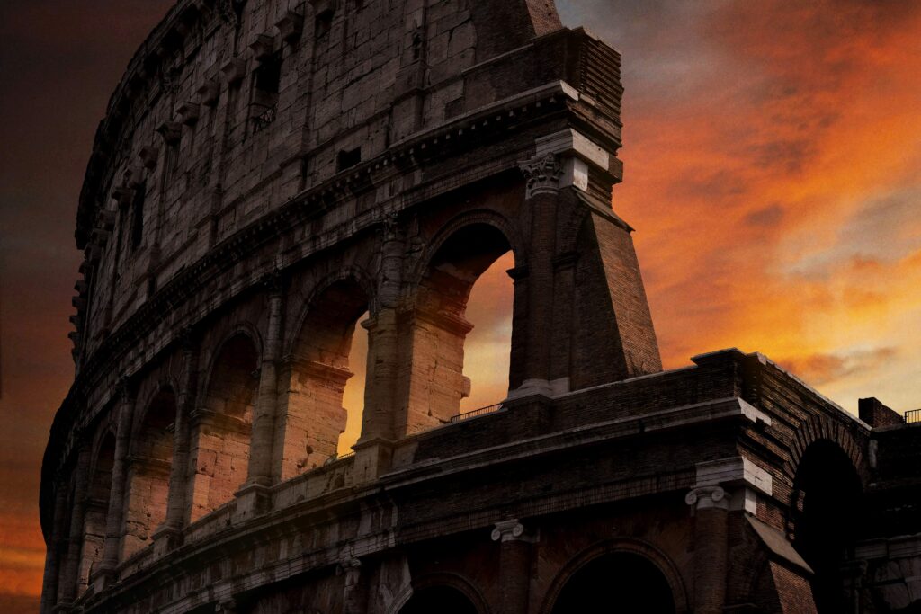 Stunning view of Rome with the Colosseum illuminated at sunset. One of the Best places to visit in europe 2025