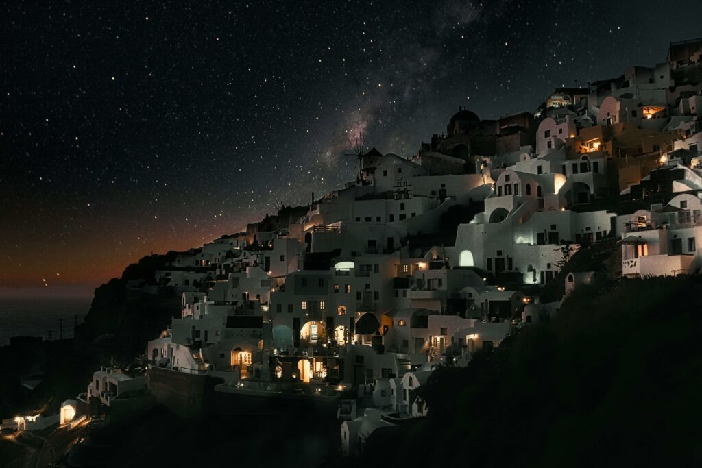 Santorini Greece view with whitewashed buildings and blue domes. one of Best places to visit in europe 2025