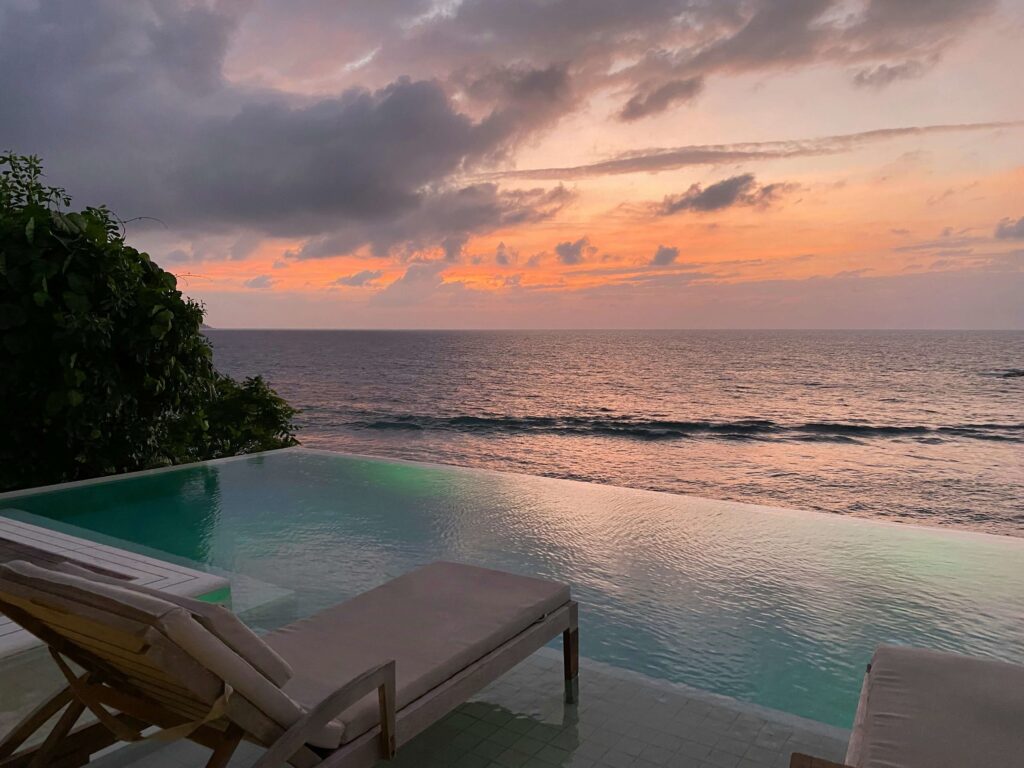 A breathtaking sunset over a secluded beach in the Seychelles, perfect for a peaceful retreat.