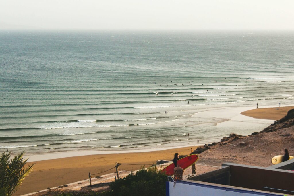 surfing in one of the best beaches in morocco , taghazout bay