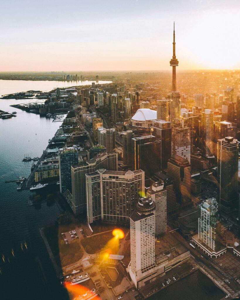 Toronto skyline featuring the iconic CN Tower and Lake Ontario at sunset. one of Best travel spots in the americas 2025